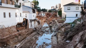 Daños causados por la DANA en Valencia, mostrando edificios y terreno afectado.