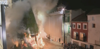 La foguera de Canals siendo consumida por las llamas durante la cremà