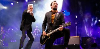 Loquillo actuando en un concierto con guitarra eléctrica