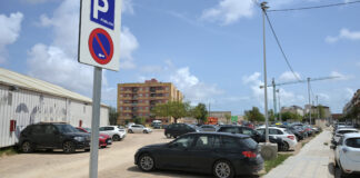 Aparcamiento público en Paiporta con señalización visible y vehículos estacionados.