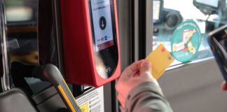 Persona utilizando un validador de tarjeta en el transporte público de València