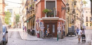 Calle en València con personas y bicicletas en un día soleado