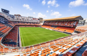 Vista del estadio Mestalla, sede del Valencia CF, con césped verde y gradas vacías.