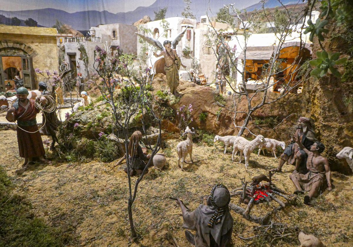 Representación de pastores en una escena de nacimiento con figuras y animales.