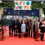 Grupo de personas en la inauguración de Expojove 2025 con decoraciones festivas.