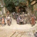 Representación de una escena histórica con artesanos y comerciantes en un pueblo antiguo.