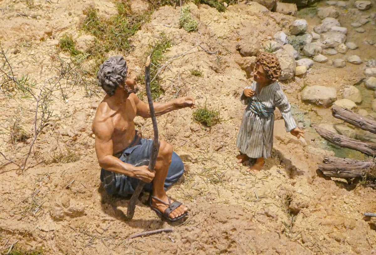 Figura de un hombre y un niño en un entorno natural