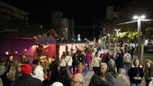 Vista del mercado de Navidad en Torrent con gente y casetas decoradas.