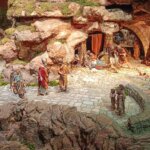 Escena de un belén con figuras artesanales en un paisaje rocoso