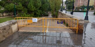 Vallas amarillas en un camino debido a la alerta roja por lluvias en Valencia.