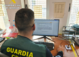 La Guardia Civil desmantela un punto de venta de cocaína en un bar local en Silla Miembro de la Guardia Civil trabajando en una oficina