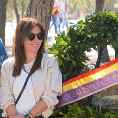 Sonia Borruey posando junto a una corona de flores con la bandera de Paterna