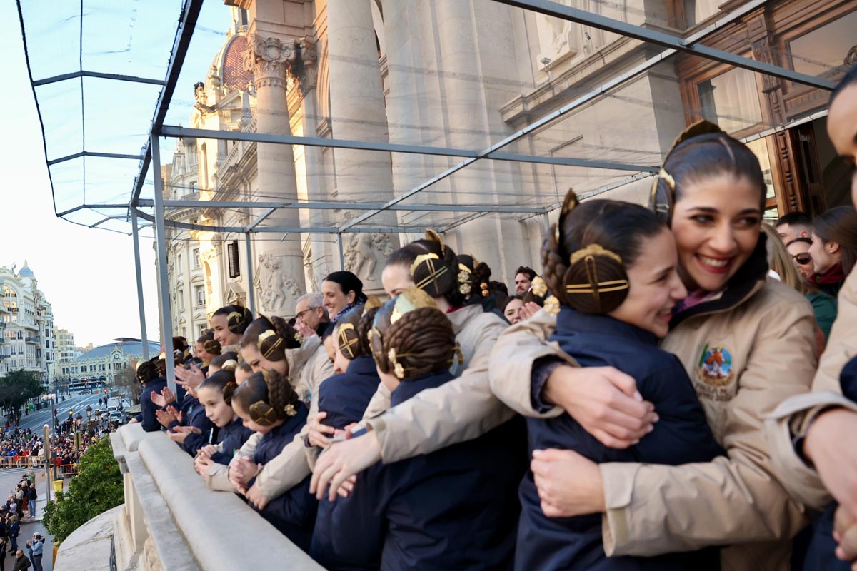 Grupo de personas con trajes tradicionales en una celebración en la calle.