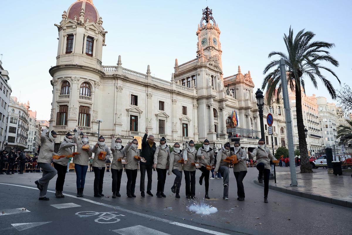 Grupo de personas celebrando en la calle frente a un edificio histórico en Valencia