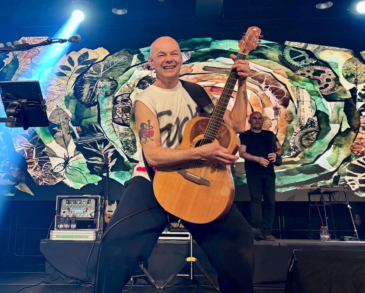 Músico de Celtas Cortos tocando la guitarra en el escenario del Roig Arena