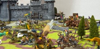 Mesa de juego con miniaturas de Warhammer Fantasy en evento de wargames