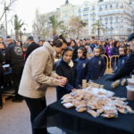 Reparto de comida en un evento con niños y adultos en la calle