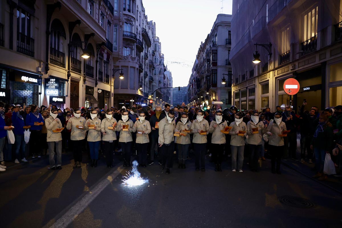 Grupo de personas con bandejas en una manifestación en la calle.