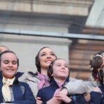Mujeres y niñas sonriendo en un evento al aire libre