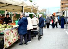 Mercado en La Pobla de Farnals con personas comprando productos frescos