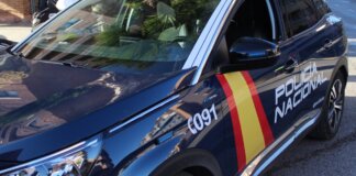 Coche de la Policía Nacional con luces encendidas en la calle