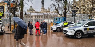Imagen de la plaza del Ayuntamiento de Valencia bajo la lluvia durante Fallas