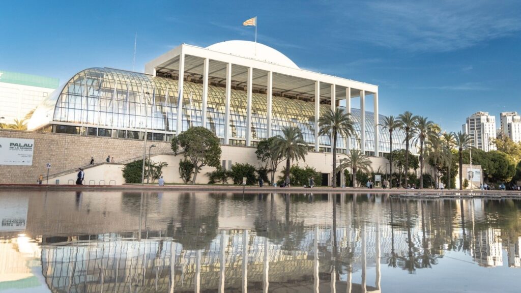 Vista exterior del Palau de la Música en Valencia con reflejo en el agua.