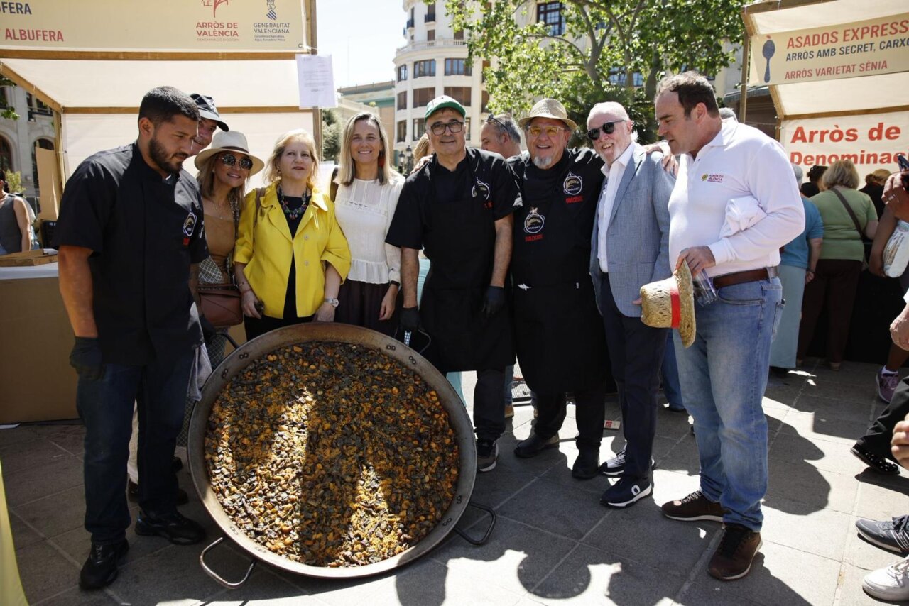 Grupo de personas en el evento TastArròs en València con una gran paella